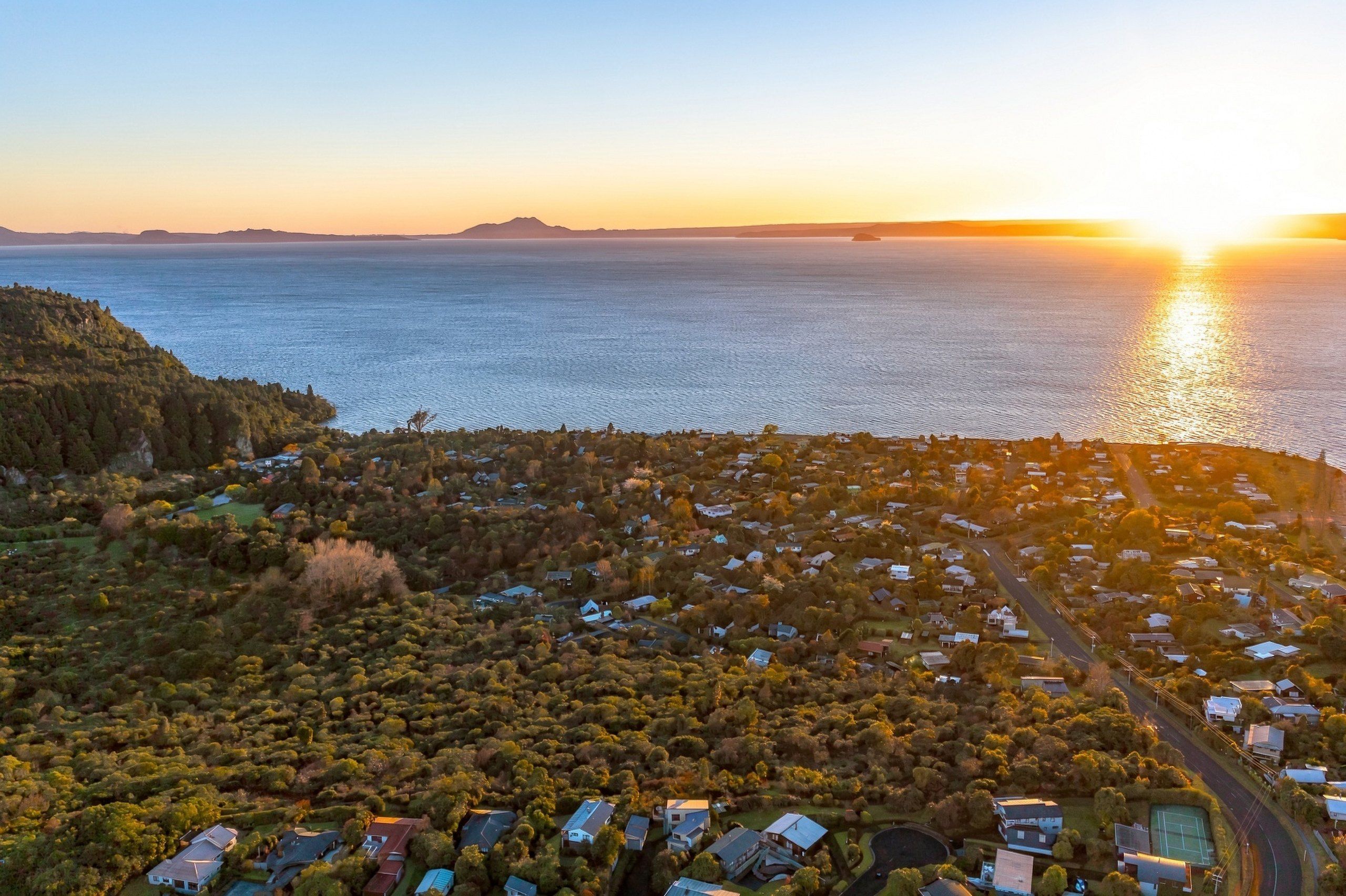 Sunset over Lake Taupō above the native bush at Kuratau
